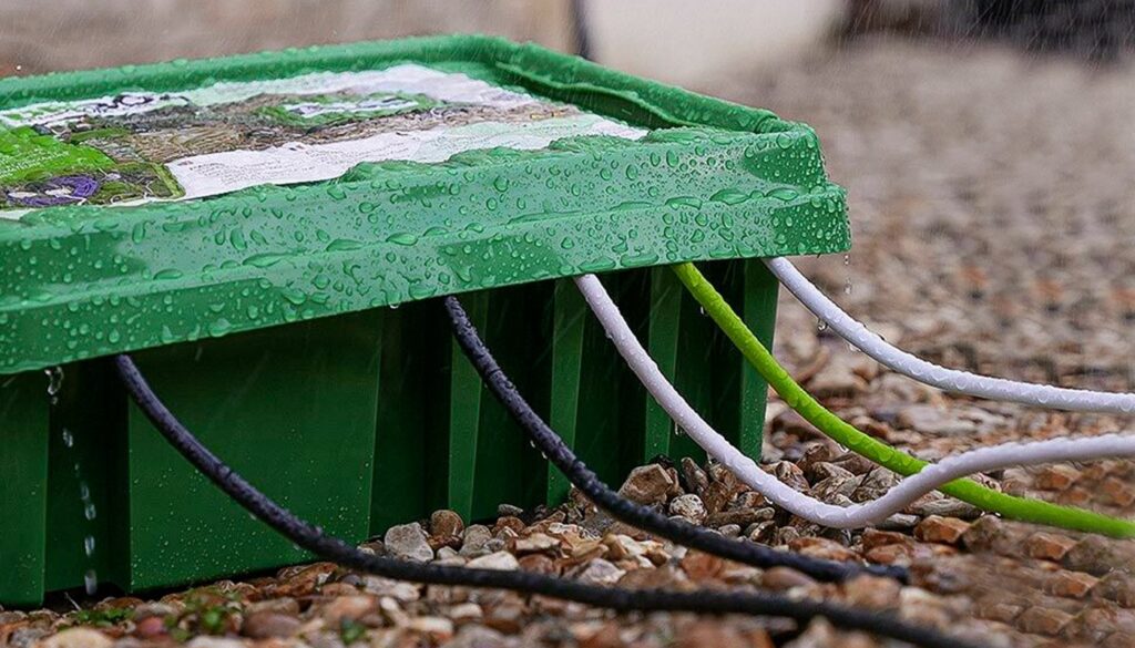 Green Dri Box weatherproof connection box in the rain with cables